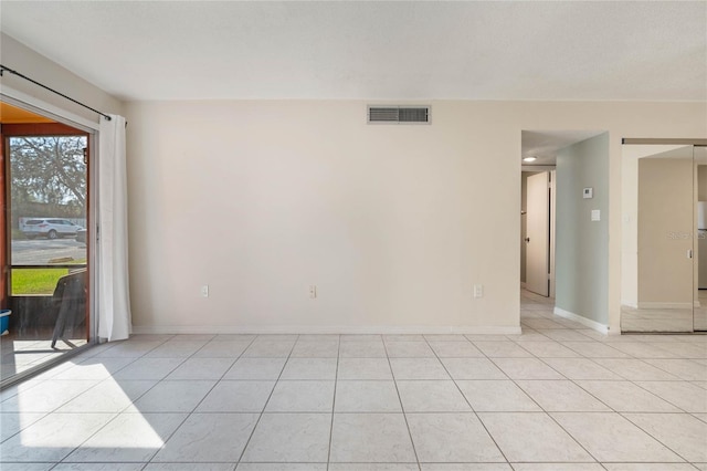 spare room featuring light tile patterned floors