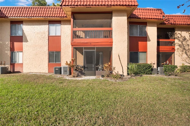 exterior space featuring central AC unit and a lawn