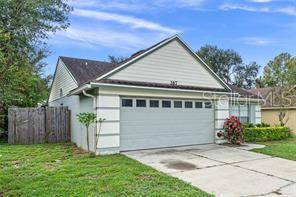 exterior space featuring a garage and a front lawn