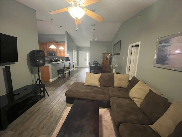 living room with ceiling fan, high vaulted ceiling, and light hardwood / wood-style flooring