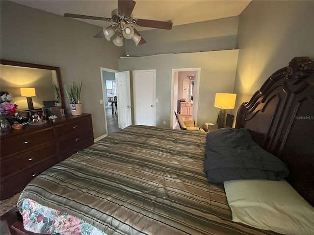 bedroom with ceiling fan, connected bathroom, and high vaulted ceiling