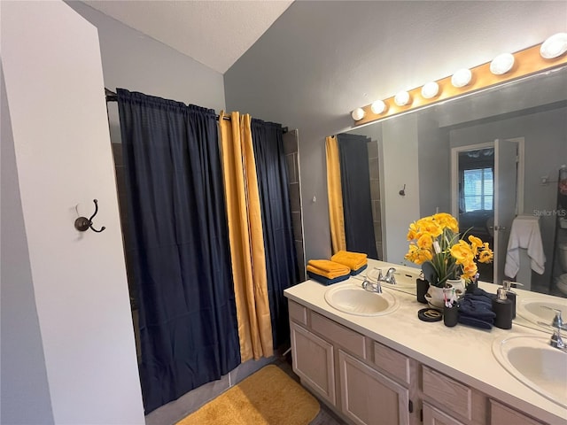 bathroom featuring vanity and curtained shower