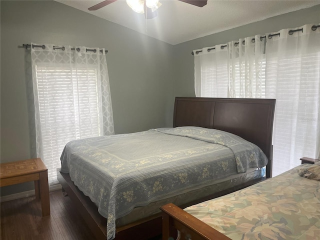 bedroom featuring ceiling fan, lofted ceiling, and dark hardwood / wood-style flooring