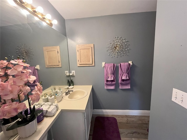 bathroom featuring hardwood / wood-style flooring and vanity