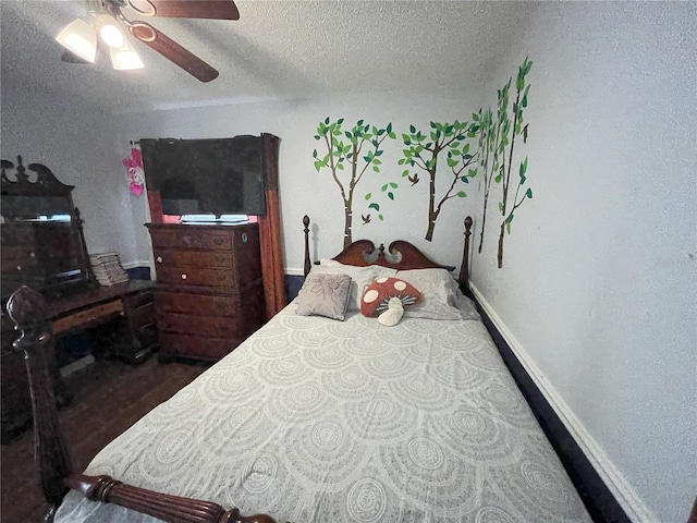 bedroom with ceiling fan and a textured ceiling