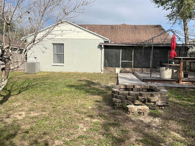 view of yard with central AC unit and a sunroom