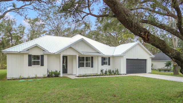 modern farmhouse featuring a garage and a front lawn