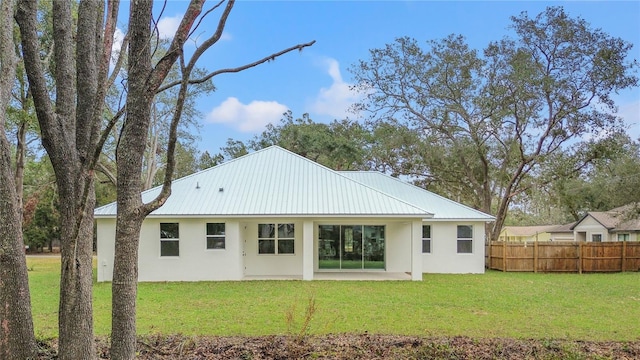 back of property featuring a yard