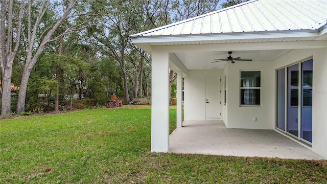 view of yard featuring ceiling fan and a patio