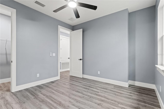 unfurnished bedroom with ceiling fan and light hardwood / wood-style floors