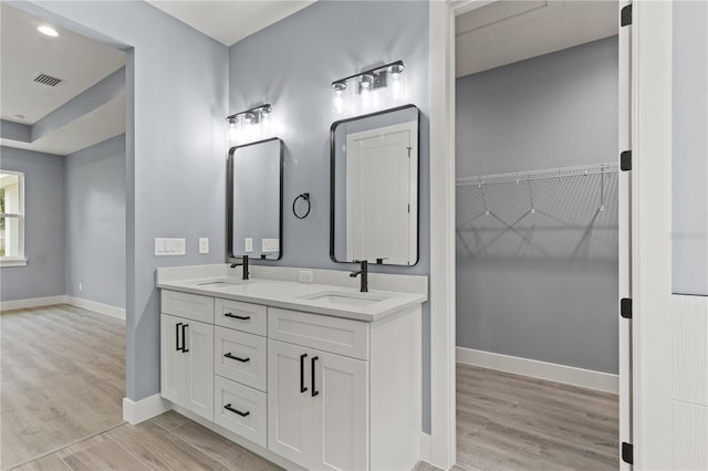 bathroom with vanity and hardwood / wood-style floors