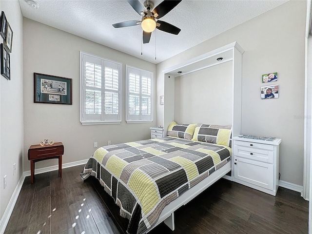 bedroom featuring a textured ceiling, dark wood-type flooring, and ceiling fan