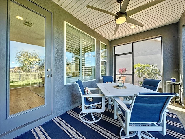 sunroom / solarium featuring wooden ceiling and ceiling fan