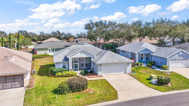 view of front of home with a garage and a front lawn