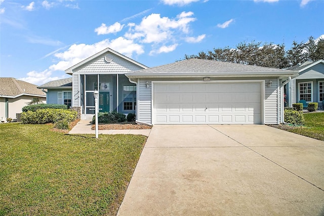 view of front facade featuring a garage, a sunroom, and a front yard