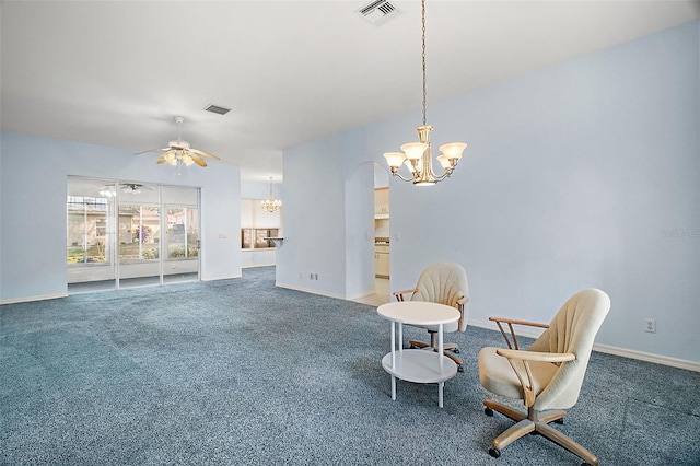 sitting room with ceiling fan with notable chandelier and carpet