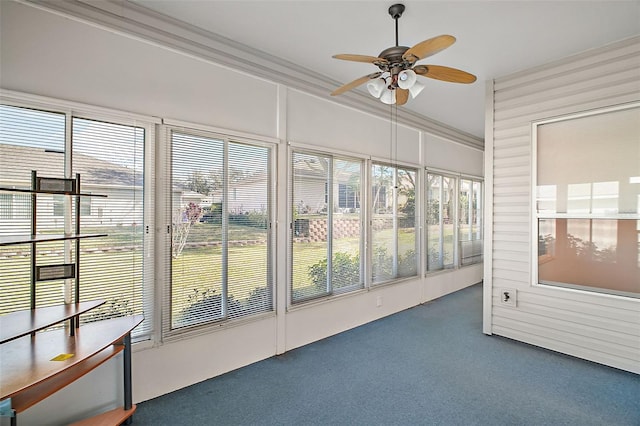 unfurnished sunroom featuring ceiling fan