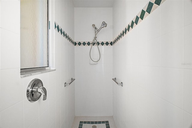 bathroom with a tile shower