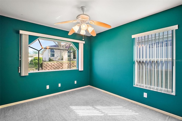 unfurnished room with carpet flooring and ceiling fan