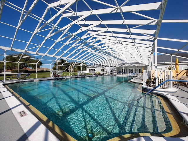 view of pool with glass enclosure