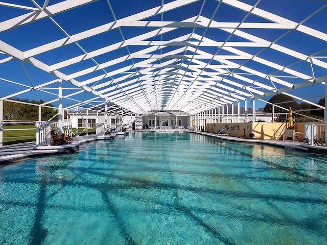 view of pool featuring glass enclosure