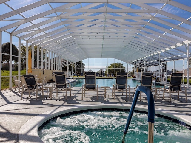 view of pool with an in ground hot tub and a water view