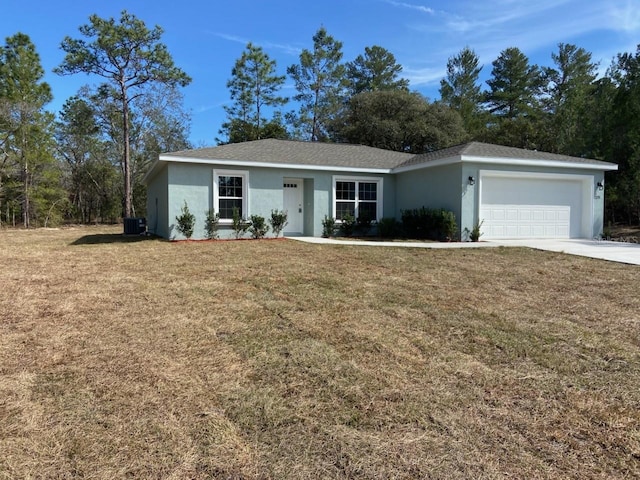 single story home featuring a garage, central AC, and a front lawn