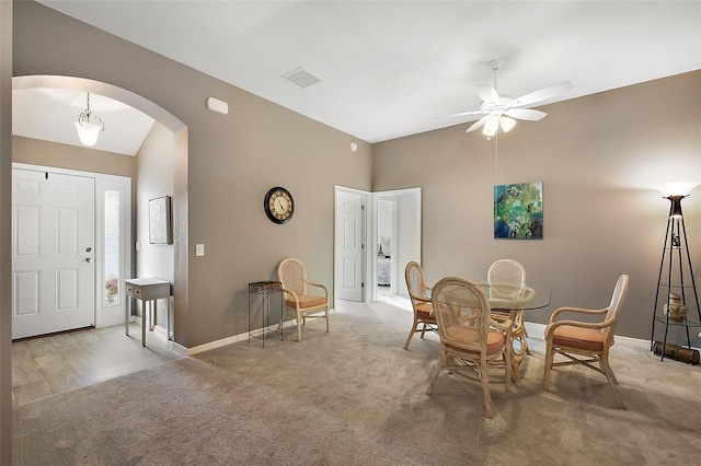 carpeted dining room with ceiling fan