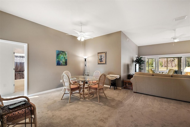 carpeted dining room with ceiling fan