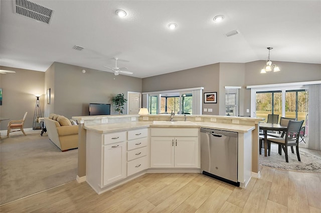 kitchen with white cabinetry, sink, stainless steel dishwasher, and an island with sink