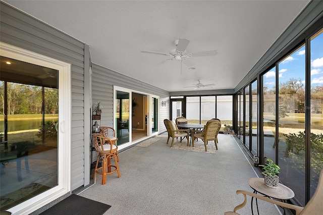 sunroom / solarium featuring ceiling fan