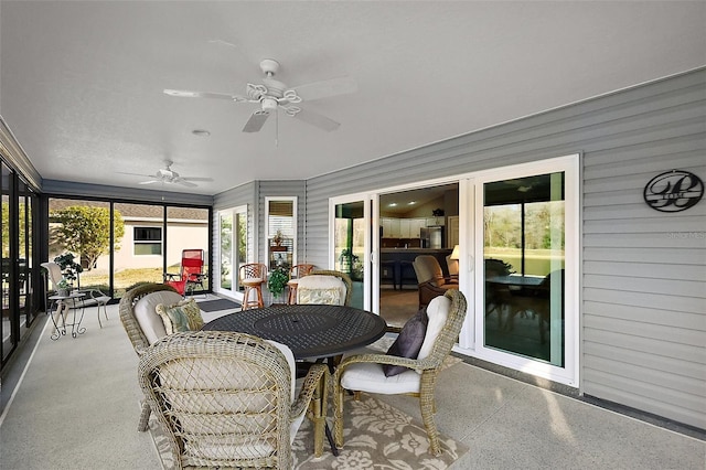 sunroom / solarium with ceiling fan