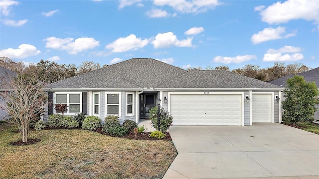 ranch-style home with a garage and a front lawn