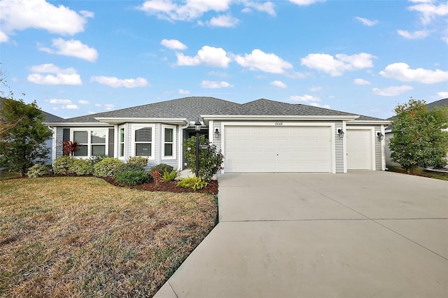 ranch-style home with a garage and a front yard