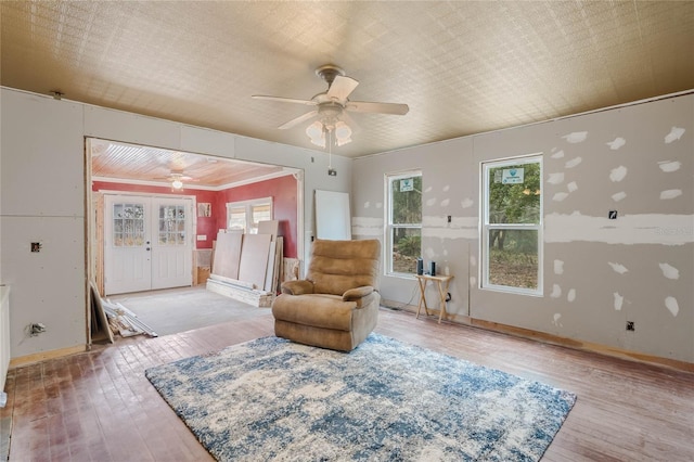 living area featuring wood-type flooring and ceiling fan