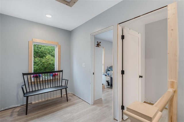 hallway with light hardwood / wood-style flooring