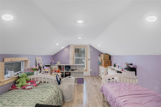 bedroom featuring lofted ceiling and light hardwood / wood-style flooring