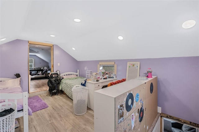 bedroom with lofted ceiling and light wood-type flooring