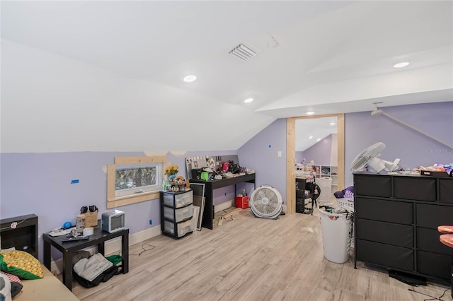 additional living space featuring vaulted ceiling and light hardwood / wood-style floors