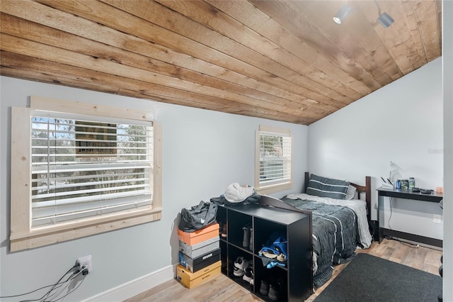 bedroom featuring vaulted ceiling, hardwood / wood-style floors, and wooden ceiling