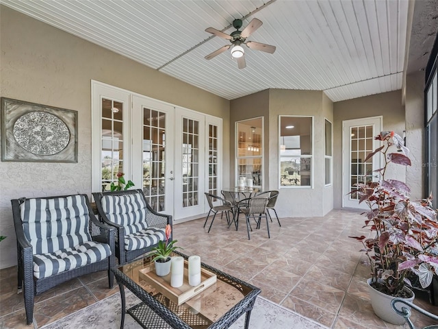 sunroom featuring wooden ceiling, ceiling fan, and french doors