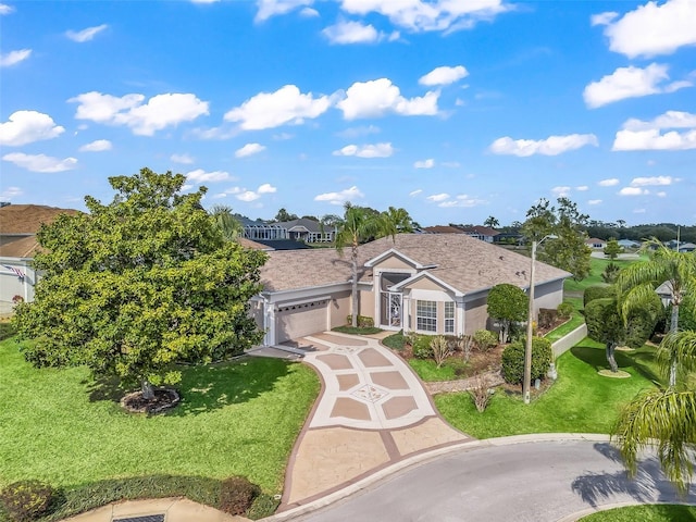 view of front of property featuring a garage and a front lawn