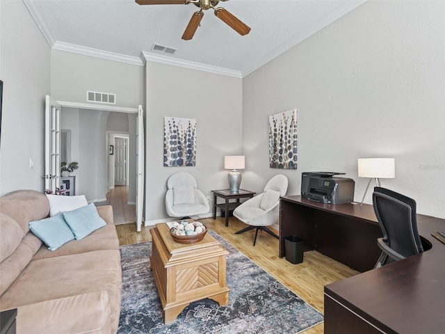 living room featuring wood-type flooring, ornamental molding, and ceiling fan