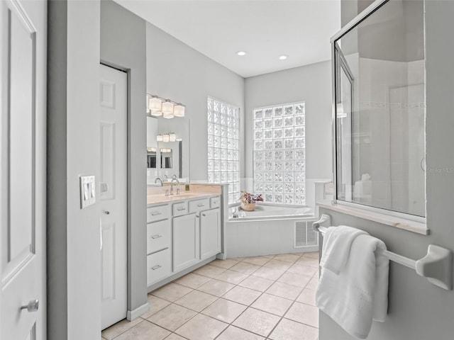 bathroom featuring tile patterned floors, vanity, and separate shower and tub