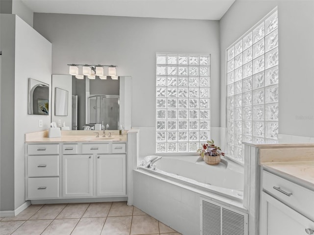 bathroom with tile patterned floors, plus walk in shower, and vanity