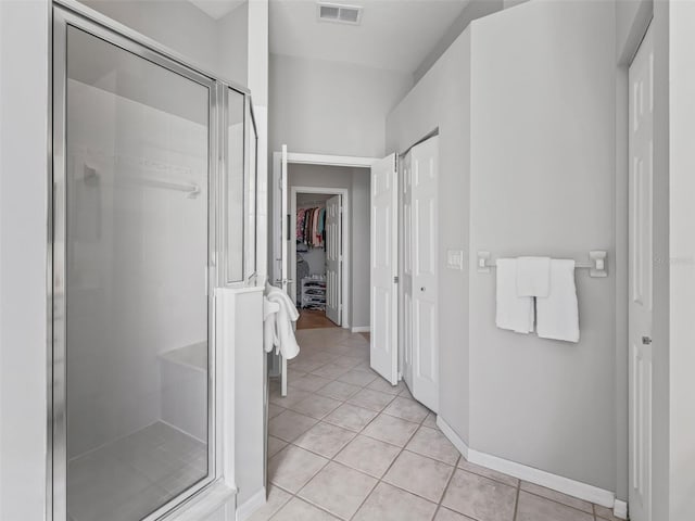 bathroom featuring tile patterned floors and a shower with shower door