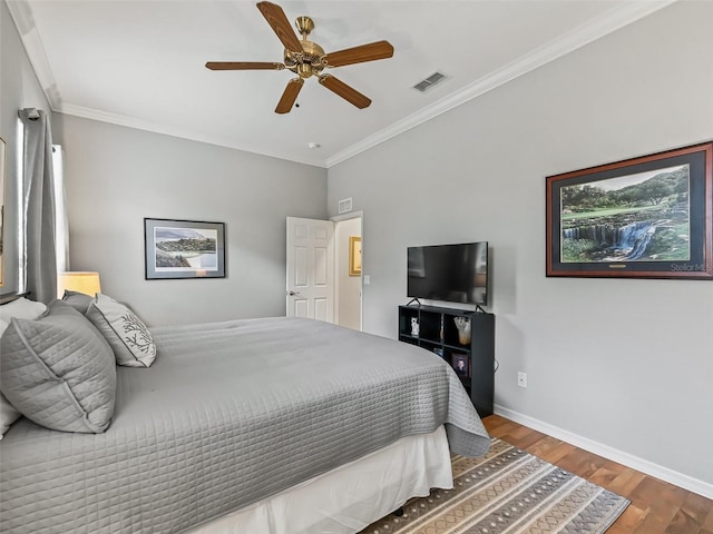 bedroom featuring wood-type flooring, ornamental molding, and ceiling fan