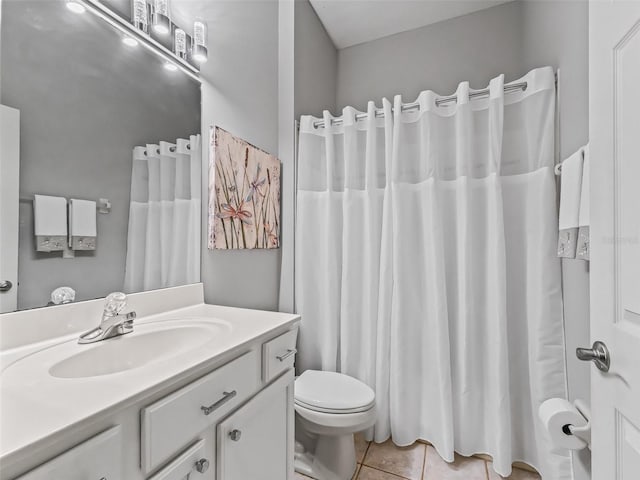 bathroom with tile patterned flooring, vanity, and toilet