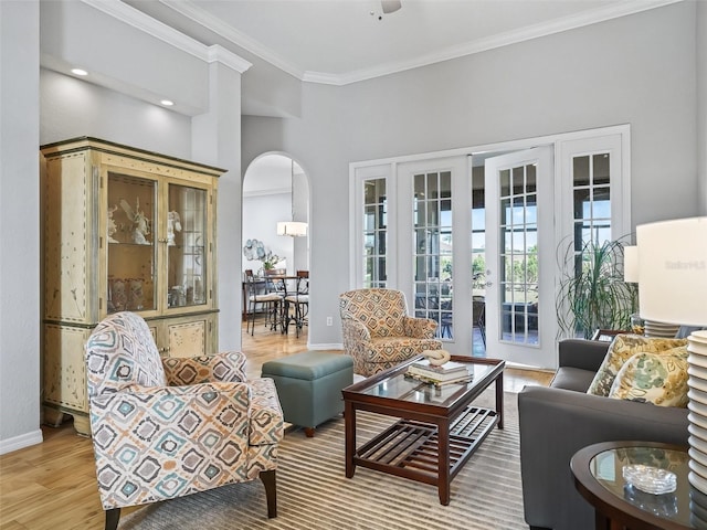 living room with ornamental molding and light hardwood / wood-style flooring