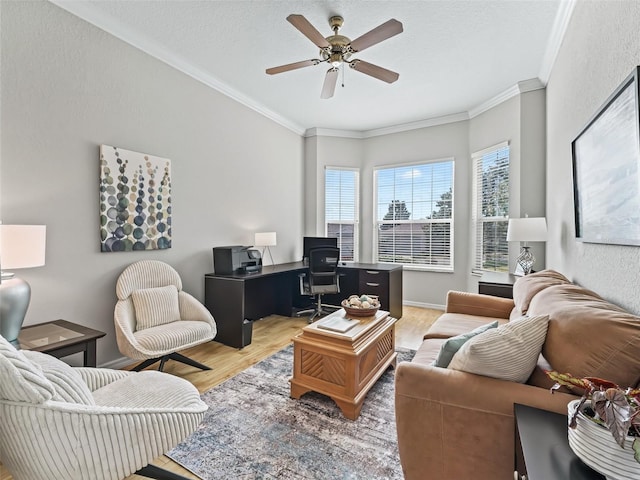 living room featuring crown molding, ceiling fan, wood-type flooring, and a textured ceiling